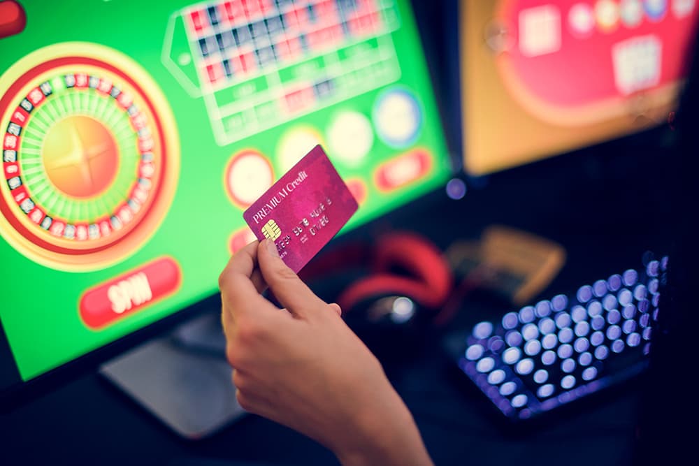 Woman holding credit card while gambling